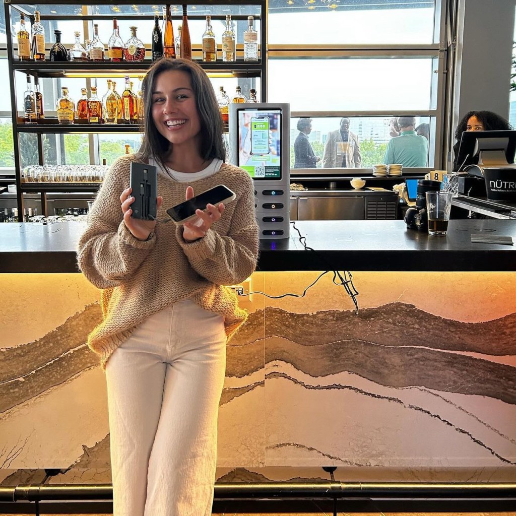 girl with phone charher power bank and kiosk